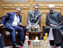 Image may contain: 3 people, people smiling, people sitting and indoor